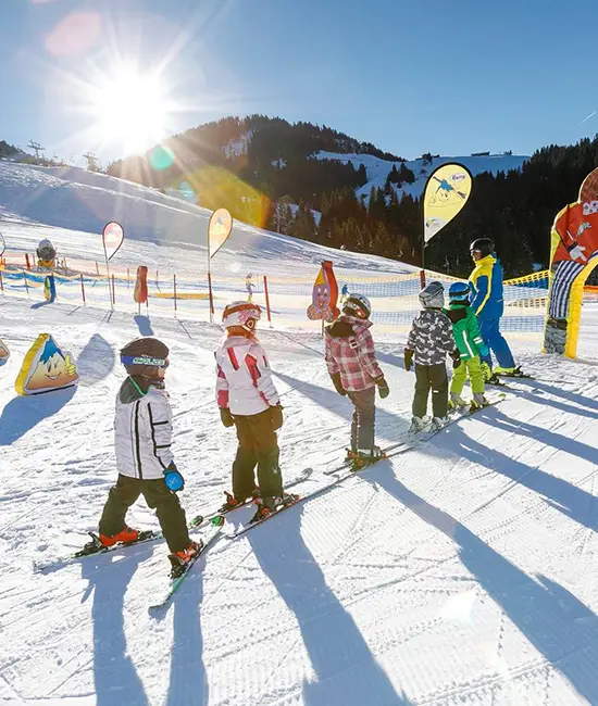 Kids skiing at ski school in soll